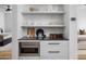 Convenient kitchenette between bedrooms with modern microwave and ample storage at 5814 E Camelback Rd, Phoenix, AZ 85018
