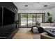 Open concept living room with backyard views and modern furnishings at 5814 E Camelback Rd, Phoenix, AZ 85018