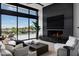 Modern living room with large windows, sleek fireplace, and upscale decor offer luxury and outdoor views at 5814 E Camelback Rd, Phoenix, AZ 85018