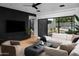 Bright living room with a large sectional sofa, modern decor, and seamless indoor-outdoor flow at 5814 E Camelback Rd, Phoenix, AZ 85018