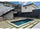Modern home with a pool, grass and stone accents, an outdoor staircase, and desert landscaping at 5814 E Camelback Rd, Phoenix, AZ 85018