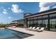 Stunning modern home featuring a sleek pool, lounge chairs, and seamless indoor-outdoor living space at 5814 E Camelback Rd, Phoenix, AZ 85018