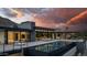 Modern backyard at sunset with a pool, lounge chairs, BBQ, an outdoor living area, and desert landscaping at 5814 E Camelback Rd, Phoenix, AZ 85018