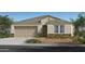 Charming single-story home featuring a neutral color palette, stone accents, and well-manicured landscaping at 5870 S 246Th Ln, Buckeye, AZ 85326