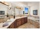 Luxury bathroom with double vanity, soaking tub, and natural stone accents at 6001 E Restin Rd, Cave Creek, AZ 85331