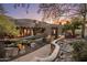 Southwest-style home featuring desert landscaping, an arched courtyard gate and covered patio at 6001 E Restin Rd, Cave Creek, AZ 85331