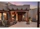 Inviting Southwest-style home with a decorative wooden front door and charming desert landscaping at 6001 E Restin Rd, Cave Creek, AZ 85331