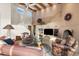 Inviting living room with high ceilings, exposed wood beams, adobe fireplace and comfortable seating arrangement at 6001 E Restin Rd, Cave Creek, AZ 85331