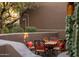 Charming patio with decorative iron table and cushioned chairs, perfect for outdoor entertaining at 6001 E Restin Rd, Cave Creek, AZ 85331