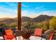 Scenic patio view featuring desert landscape, distant mountains, and outdoor seating under a bright sky at 6001 E Restin Rd, Cave Creek, AZ 85331