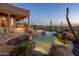 Beautiful backyard pool area with stunning desert views at twilight at 6001 E Restin Rd, Cave Creek, AZ 85331