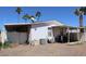Exterior view of a mobile home with an attached shed at 625 W Mckellips Rd # 279, Mesa, AZ 85201