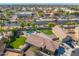 Home with a pool and green yard in a convenient location near businesses, captured in a detailed aerial shot at 6763 W Wethersfield Rd, Peoria, AZ 85381