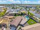 Aerial view showcasing a home with a sparkling pool, trampoline, and under-construction building in a community setting at 6763 W Wethersfield Rd, Peoria, AZ 85381