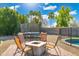 Landscaped backyard with fire pit, trampoline, and pool, offering a relaxing outdoor experience at 6763 W Wethersfield Rd, Peoria, AZ 85381
