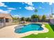 Backyard featuring a pool, trampoline, seating, and mature trees, perfect for relaxation and recreation at 6763 W Wethersfield Rd, Peoria, AZ 85381