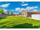 Vast backyard with a lush lawn, trampoline, and paver patio, creating a perfect outdoor oasis for recreation and relaxation at 6763 W Wethersfield Rd, Peoria, AZ 85381