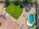Aerial view of a well-maintained backyard featuring a pool, trampoline, and spacious grassy area at 6763 W Wethersfield Rd, Peoria, AZ 85381