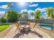 Spacious backyard featuring a brick patio with fire pit and a trampoline at 6763 W Wethersfield Rd, Peoria, AZ 85381