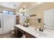 Bathroom featuring double sinks, modern fixtures, and wood-look flooring at 6763 W Wethersfield Rd, Peoria, AZ 85381