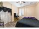 Bedroom featuring hardwood floors, plantation shutters, and a vanity with a chair at 6763 W Wethersfield Rd, Peoria, AZ 85381