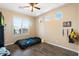 Bedroom featuring a large window with plantation shutters and wood-look flooring at 6763 W Wethersfield Rd, Peoria, AZ 85381