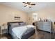 Bedroom featuring hardwood floors, a large bed, and dresser at 6763 W Wethersfield Rd, Peoria, AZ 85381