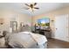 Bedroom with a large bed, a TV, and a view of the Primary bathroom at 6763 W Wethersfield Rd, Peoria, AZ 85381