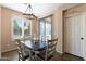 Bright dining area with a chandelier and a view of the well-maintained backyard at 6763 W Wethersfield Rd, Peoria, AZ 85381