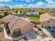 Aerial view of a charming single-Gathering home with a pool, firepit, and a detached garage at 6763 W Wethersfield Rd, Peoria, AZ 85381