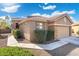 Charming single-story home featuring a tile roof, well-manicured landscaping, and a two-car garage at 6763 W Wethersfield Rd, Peoria, AZ 85381