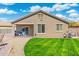 Back exterior of the home with a manicured lawn and patio, perfect for outdoor living and entertaining at 6763 W Wethersfield Rd, Peoria, AZ 85381