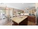 Kitchen island with seating, open to the dining area, perfect for Gathering meals and entertaining at 6763 W Wethersfield Rd, Peoria, AZ 85381