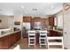 Bright eat-in kitchen boasts stainless steel appliances, and granite counters with convenient bar stool seating at 6763 W Wethersfield Rd, Peoria, AZ 85381