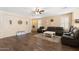 Spacious living room featuring tile floors, natural light, and comfortable seating at 6763 W Wethersfield Rd, Peoria, AZ 85381
