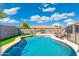 Sparkling pool surrounded by a patio, lounge chairs, and artificial turf for low-maintenance outdoor enjoyment at 6763 W Wethersfield Rd, Peoria, AZ 85381