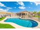 Sparkling pool with tanning chairs, surrounded by desert landscaping and a secure fence at 6763 W Wethersfield Rd, Peoria, AZ 85381