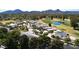 Aerial view of a community with homes near a golf course and pond at 7141 E Ironwood Dr, Paradise Valley, AZ 85253