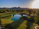 Scenic aerial view of the golf course with serene pond and mountain backdrop at 7141 E Ironwood Dr, Paradise Valley, AZ 85253