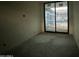 Bedroom under construction with concrete floor and large sliding glass door to backyard at 7141 E Ironwood Dr, Paradise Valley, AZ 85253