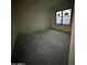 Bedroom under construction with concrete floor and large picture window offering natural light at 7141 E Ironwood Dr, Paradise Valley, AZ 85253