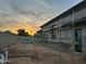 Modern home exterior under construction featuring stucco walls and large window openings at sunset at 7141 E Ironwood Dr, Paradise Valley, AZ 85253