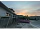 New home under construction with a pink dumpster and scaffolding against a colorful sunset sky at 7141 E Ironwood Dr, Paradise Valley, AZ 85253