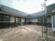 Modern gray building courtyard under construction with scaffolding and large windows at 7141 E Ironwood Dr, Paradise Valley, AZ 85253