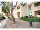 Exterior view of condo complex with well-maintained landscaping and pet waste station at 7575 E Indian Bend Rd # 1012, Scottsdale, AZ 85250