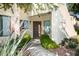 Charming front entrance featuring a wooden door, tasteful landscaping, and a welcoming walkway at 7575 E Indian Bend Rd # 1012, Scottsdale, AZ 85250