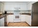 Bright kitchen featuring white cabinetry, laminate countertops, and stainless steel refrigerator at 7575 E Indian Bend Rd # 1012, Scottsdale, AZ 85250