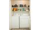 Convenient laundry room with washer, dryer, and shelving for storage at 7575 E Indian Bend Rd # 1012, Scottsdale, AZ 85250