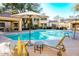 Sparkling community pool with lounge chairs and umbrellas, perfect for relaxing in the sun at 7575 E Indian Bend Rd # 1012, Scottsdale, AZ 85250