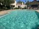 Community pool with clear blue water, lounge chairs, and umbrellas for residents enjoyment at 7575 E Indian Bend Rd # 1012, Scottsdale, AZ 85250